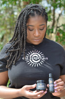 woman with locs holding whipped shea body butter and hair oil